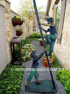 Team work bronze sculpture of two boys playing on ladder for outdoor display