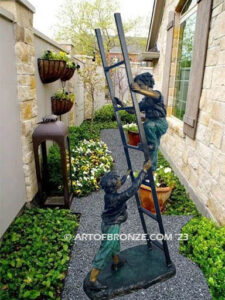 Team work bronze sculpture of two boys playing on ladder for outdoor display