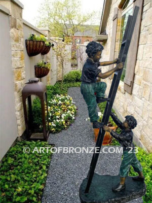 Team work bronze sculpture of two boys playing on ladder for outdoor display