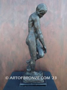 Agony figurative statue of tormented nude male with tightened musculature and twisting body