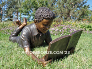 Best in His Class bronze statue of young African American boy reading his favorite novel