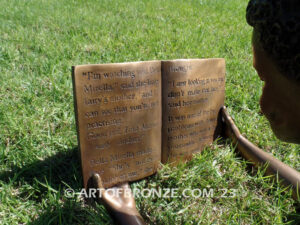 Best in His Class bronze statue of young African American boy reading his favorite novel