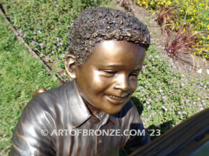 Best in His Class bronze statue of young African American boy reading his favorite novel