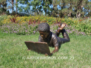 Best in His Class bronze statue of young African American boy reading his favorite novel