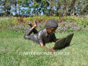 Best in His Class bronze statue of young African American boy reading his favorite novel