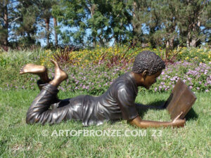 Best in His Class bronze statue of young African American boy reading his favorite novel