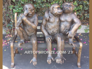 Threes a crowd whimsical bronze statue of three monkeys sitting on bronze bench