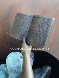 Book Smart bronze sculpture of seated girl reading book with smiling expression