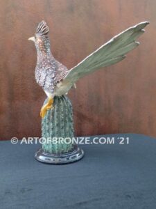 Desert Runner bronze sculpture of roadrunner resting atop a cactus