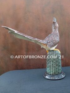 Desert Runner bronze sculpture of roadrunner resting atop a cactus