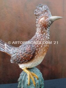 Desert Runner bronze sculpture of roadrunner resting atop a cactus