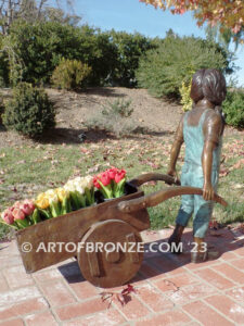 Gardening Day bronze statue of girl pulling wheelbarrow/cart for yard display