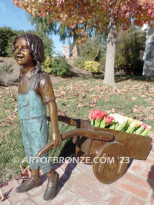 Gardening Day bronze statue of girl pulling wheelbarrow/cart for yard display