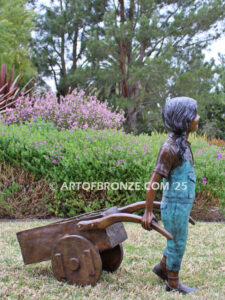 Gardening Day bronze statue of girl pulling wheelbarrow/cart for yard display