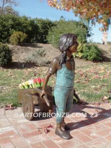 Gardening Day bronze statue of girl pulling wheelbarrow/cart for yard display