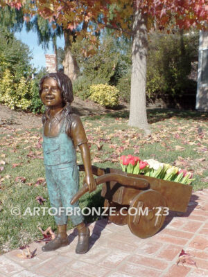 Gardening Day bronze statue of girl pulling wheelbarrow/cart for yard display