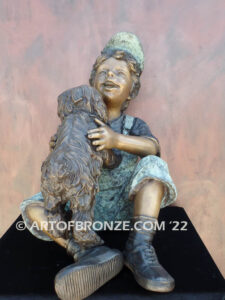 Best Buddies bronze sculpture of young boy petting his dog on his lap