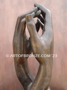 The Cathedral bronze sculpture of two life-like right hands touching