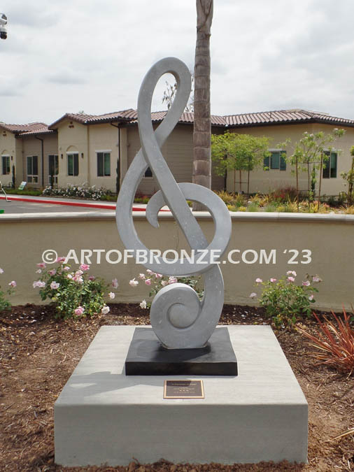 Signature of Time bronze sculpture of monumental Treble Clef musical note for Cogir Senior Living Center in Brea, CA