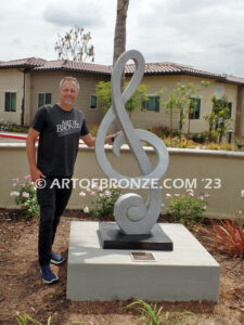 Signature of Time bronze sculpture of monumental Treble Clef musical note for Cogir Senior Living Center in Brea, CA
