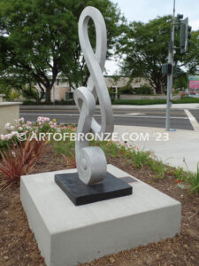 Signature of Time bronze sculpture of monumental Treble Clef musical note for Cogir Senior Living Center in Brea, CA