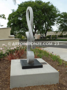 Signature of Time bronze sculpture of monumental Treble Clef musical note for Cogir Senior Living Center in Brea, CA