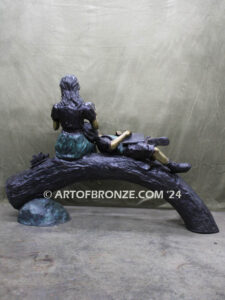 Break Time monumental bronze sculpture two children reading book on log