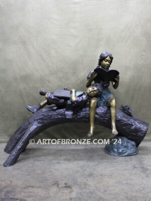 Break Time monumental bronze sculpture two children reading book on log