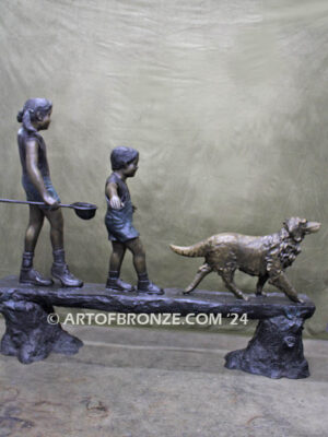 Day of Adventure bronze sculpture of two children and dog strolling across bronze log