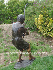 Fisher Boy bronze statue of young boy holding pole and trying to catch a fish