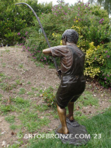 Fisher Boy bronze statue of young boy holding pole and trying to catch a fish