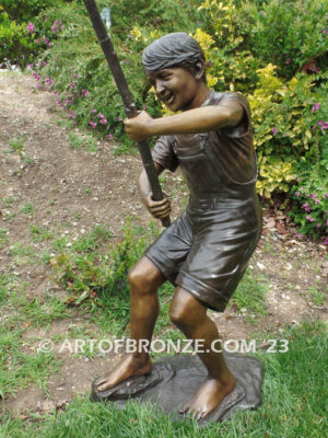 Fisher Boy bronze statue of young boy holding pole and trying to catch a fish