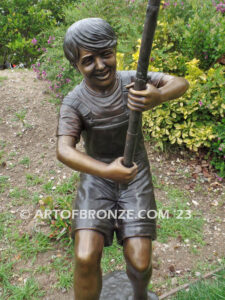 Fisher Boy bronze statue of young boy holding pole and trying to catch a fish