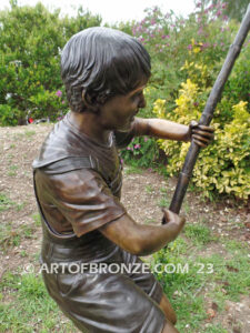 Fisher Boy bronze statue of young boy holding pole and trying to catch a fish