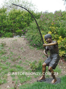 Fisher Boy bronze statue of young boy holding pole and trying to catch a fish