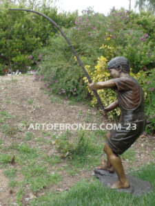 Fisher Boy bronze statue of young boy holding pole and trying to catch a fish