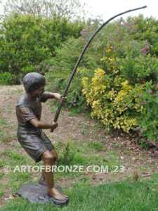 Fisher Boy bronze statue of young boy holding pole and trying to catch a fish