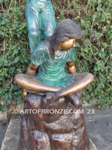 High Hopes bronze sculpture of four children playing on bronze rock for park or school playground