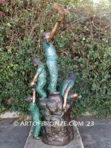 High Hopes bronze sculpture of four children playing on bronze rock for park or school playground