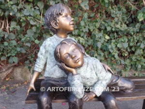 Cherished Moments bronze statue of two kids relaxing on bench