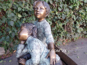 Cherished Moments bronze statue of two kids relaxing on bench