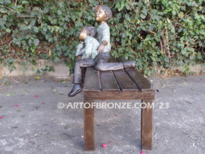 Cherished Moments bronze statue of two kids relaxing on bench
