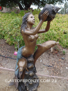 Bronze mermaid sea goddess statue swimming with dolphins holding shell for pond, pool or aquatic display