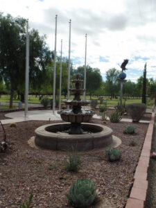 Evergreen Cemetery Veterans Memorial bronze statues of eagle on globe and boy saluting flag