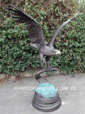 Majesty monumental bronze sculpture of eagle landing on branch