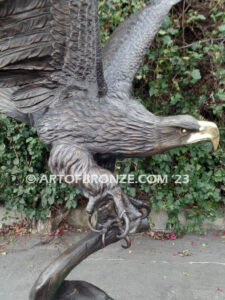 Majesty monumental bronze sculpture of eagle landing on branch