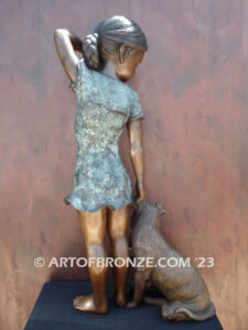 Girls Best Friend bronze sculpture of girl playing with puppy