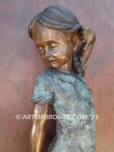 Girls Best Friend bronze sculpture of girl playing with puppy