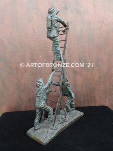 Rising bravery bronze statue of three firefighters climbing ladder battling fire