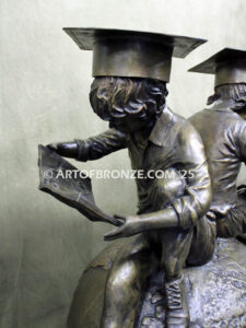 Global Scholars bronze statue of boy and girl sitting on globe reading book